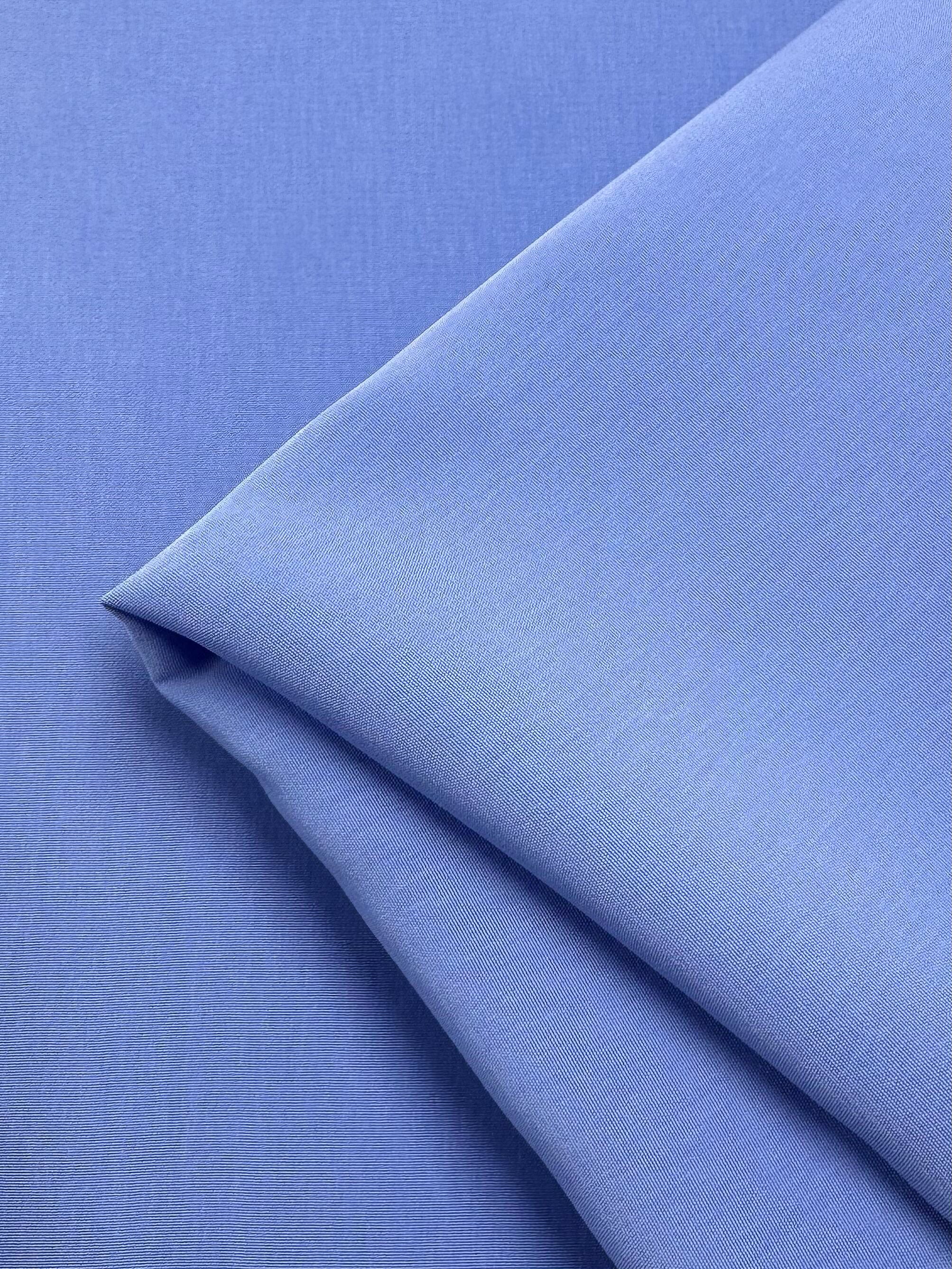 The Microfibre Suiting - Azurine by Super Cheap Fabrics features a neatly folded, smooth microfibre surface with a soft sheen and medium weight, highlighting its crispness and quality. Width: 150cm.