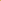 A close-up of Super Cheap Fabrics’ Soft Tulle - Yellow - 150cm, a sheer, lightweight fabric ideal for veils, shown folded on a smooth white surface.