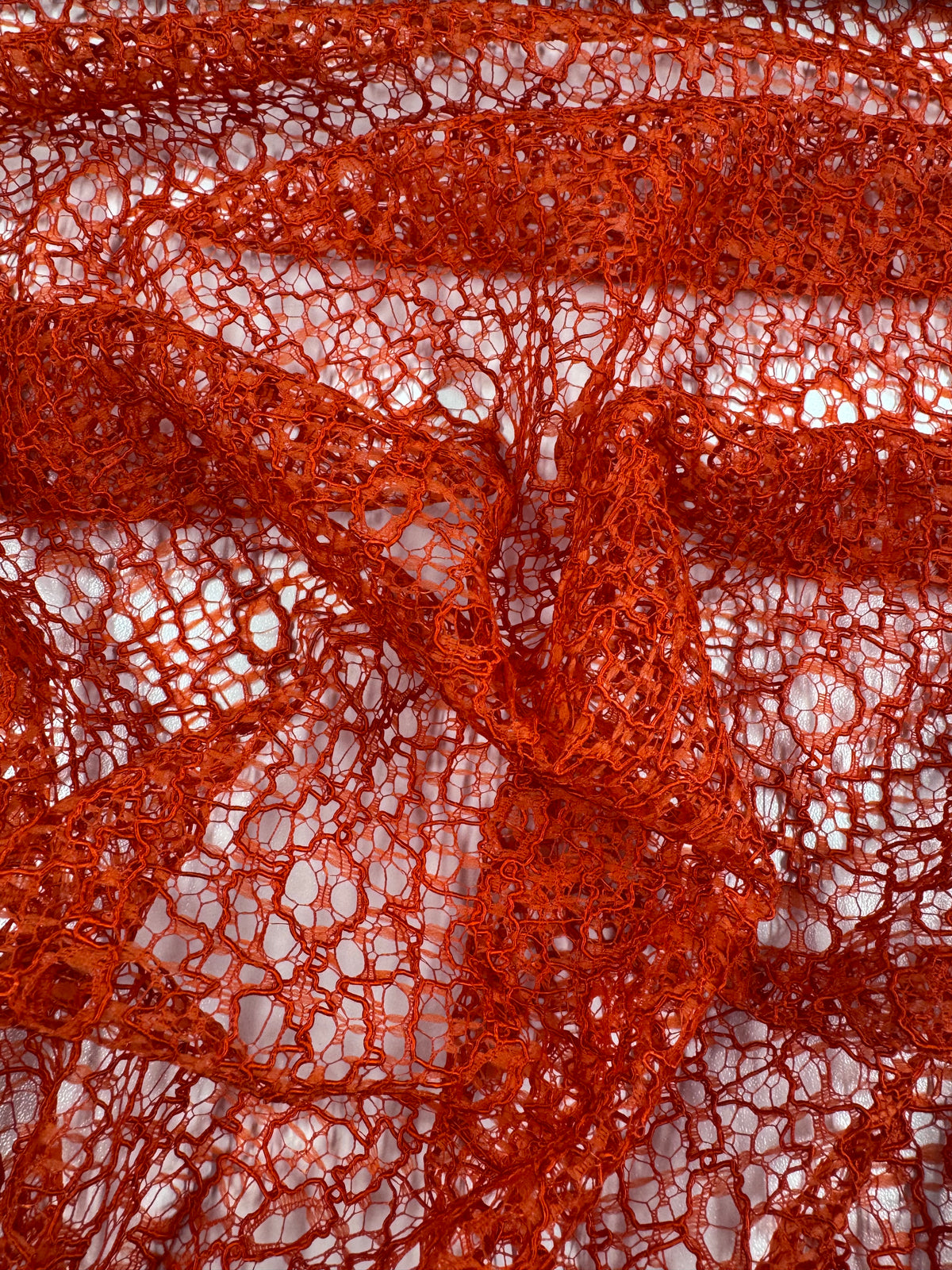 Orange cotton lace fabric close up