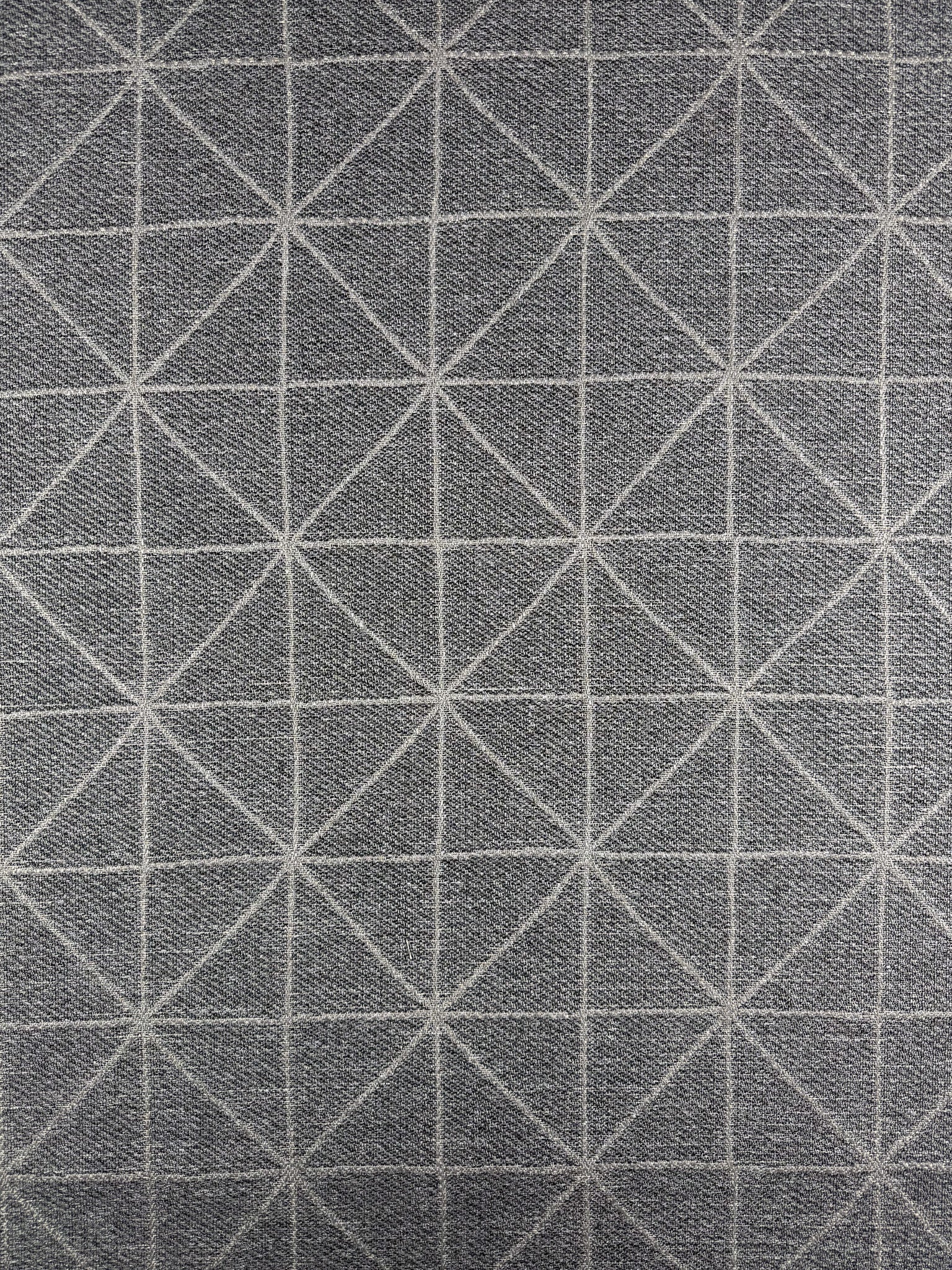 Super Cheap Fabrics' Linen Viscose - Quentin Silver (156cm) features a gray luxurious woven fabric with a geometric grid of white triangles and diamonds, made from extra heavy weight linen. The symmetrical design is evenly spaced across the surface.