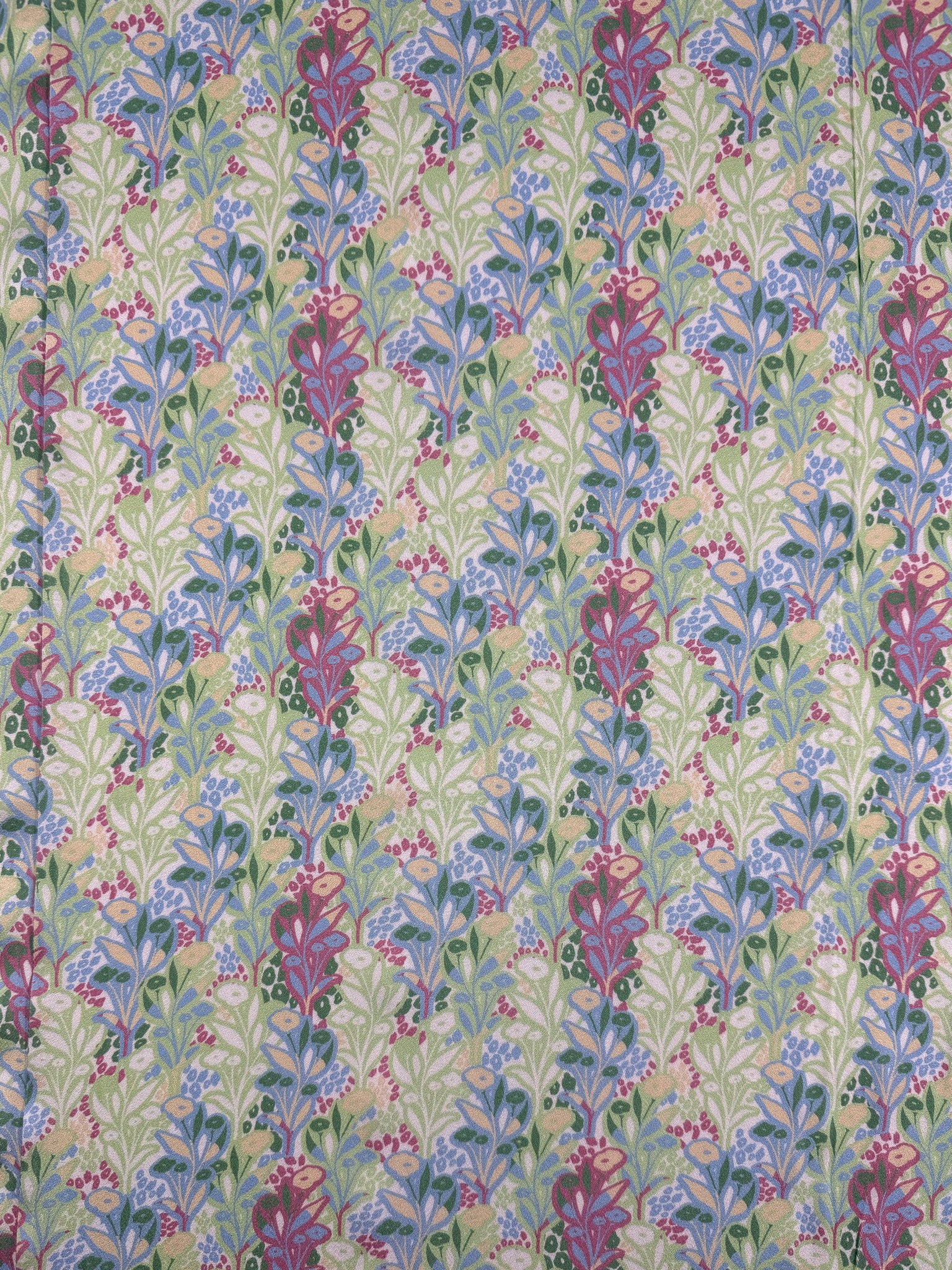 Mercerised Rayon - Garden Vine by Super Cheap Fabrics features a vibrant, symmetrical floral pattern in pink, purple, and blue with green leaves on a light background—ideal for breathable, lightweight garments. Width: 150cm.