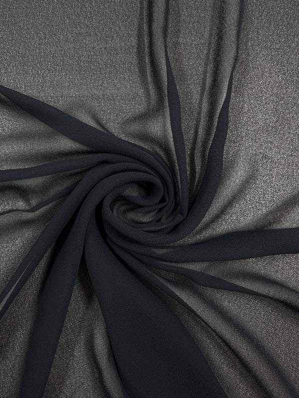 A close-up of Super Cheap Fabrics’ Hi-Multi Chiffon in Navy (150cm) shows its sheer polyester texture, soft folds, and subtle shimmer arranged in a spiral pattern.