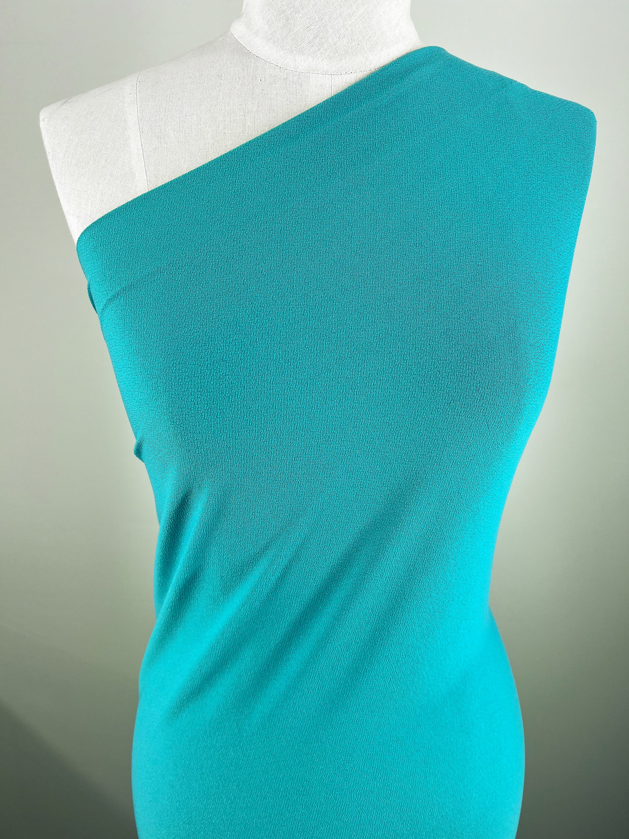 A turquoise, one-shoulder dress in 
