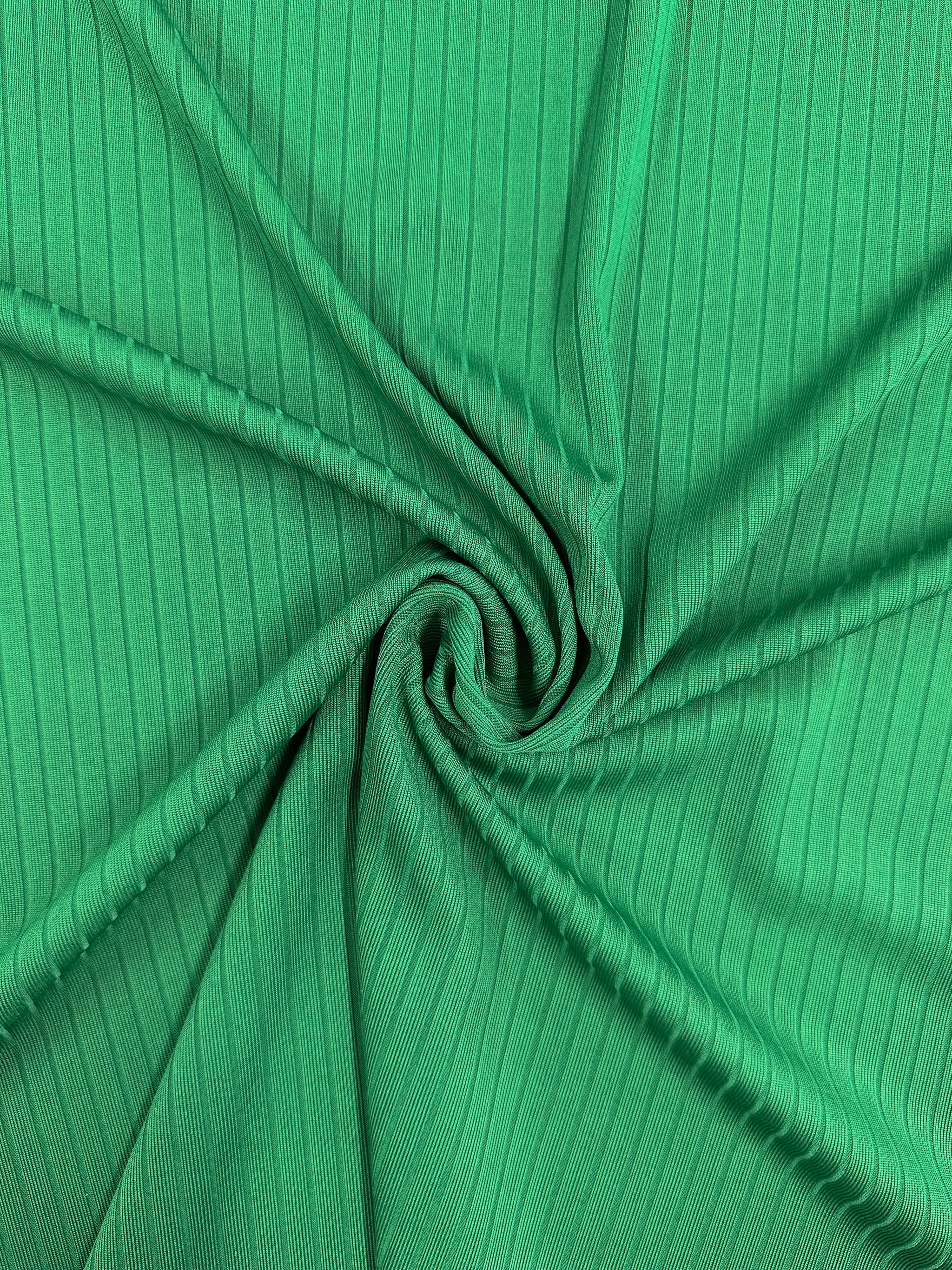 Close-up of Super Cheap Fabrics' Rib Knit - Abundant Green - 177cm, swirled in the center for a spiral effect. The texture highlights visible vertical ribbing and generous stretch.